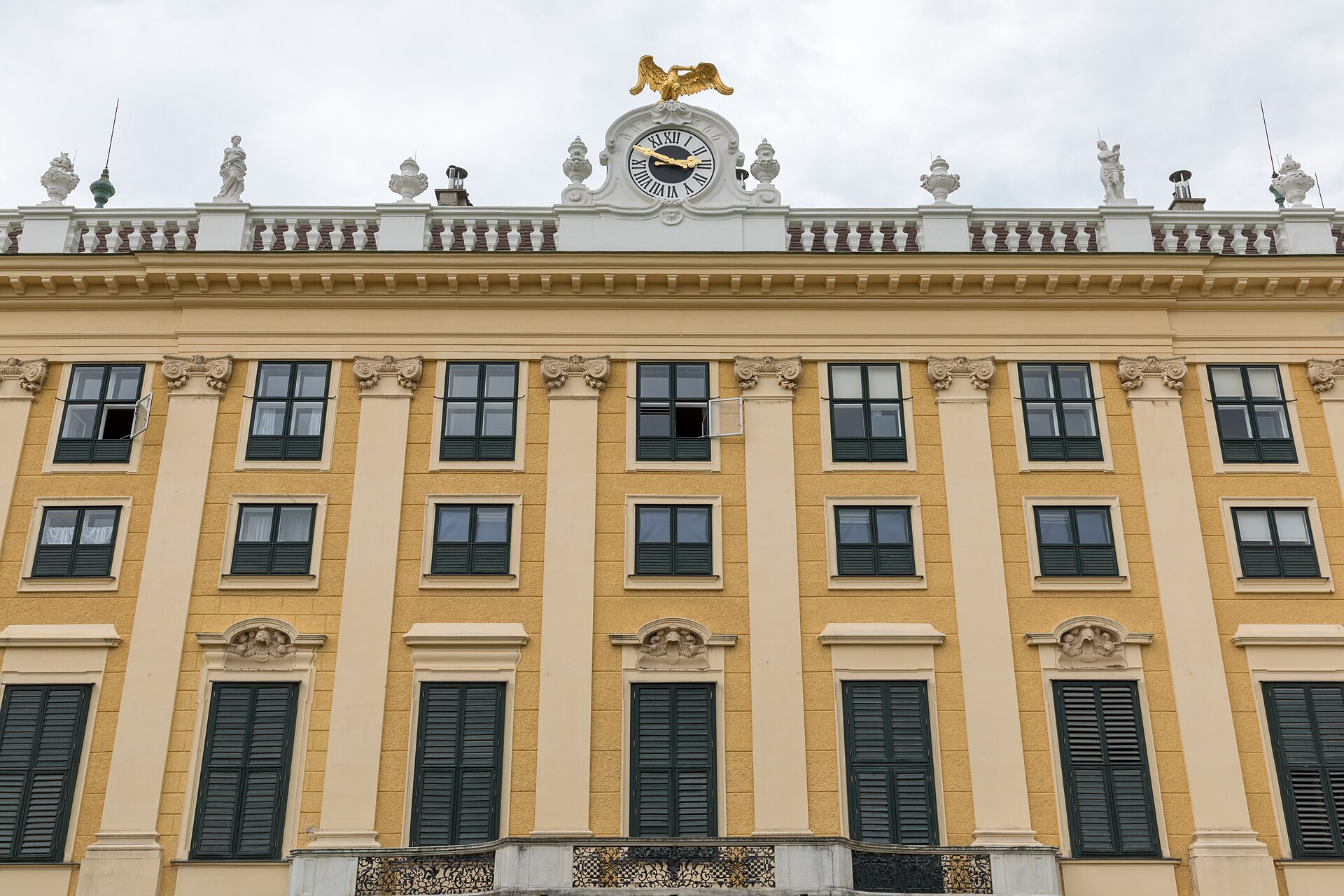 Ochre facade and clock at Schönbrunn Palace in Vienna